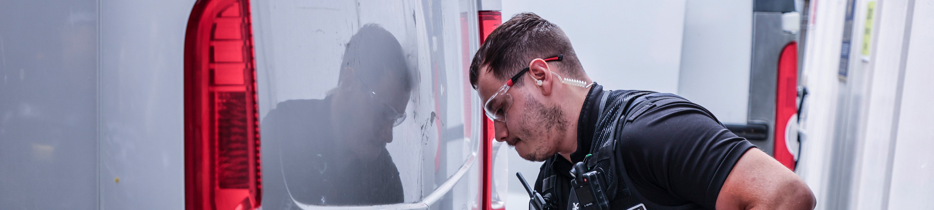 Police opening the back of a van with a metal bar